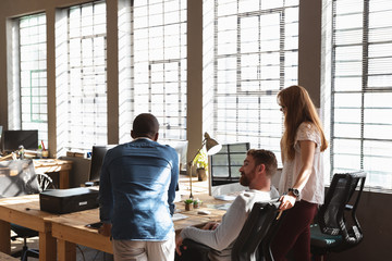 Young creative professionals working in a sunlit office