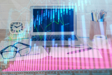 Financial chart drawing and table with computer on background. Double exposure. Concept of international markets.