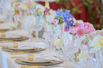 Banquet table set with silverware, napkin and glass at restaurant before party