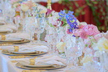 Banquet table set with silverware, napkin and glass at restaurant before party