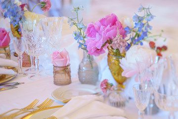 Elegant dinner table set with silverware, napkin and glass at restaurant before party