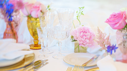 Elegant dinner table set with silverware, napkin and glass at restaurant before party