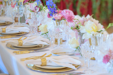 Elegant dinner table set with silverware, napkin and glass at restaurant before party
