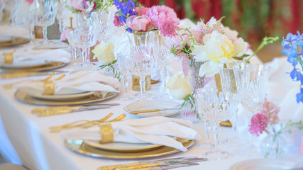 Elegant dinner table set with silverware, napkin and glass at restaurant before party