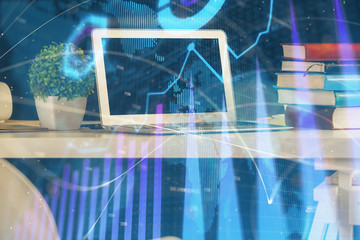 Financial chart drawing and table with computer on background. Multi exposure. Concept of international markets.