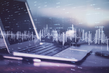 Forex market graph hologram and personal computer on background. Multi exposure. Concept of investment.