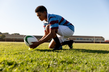 Young adult female rugby player on a rugby pitch