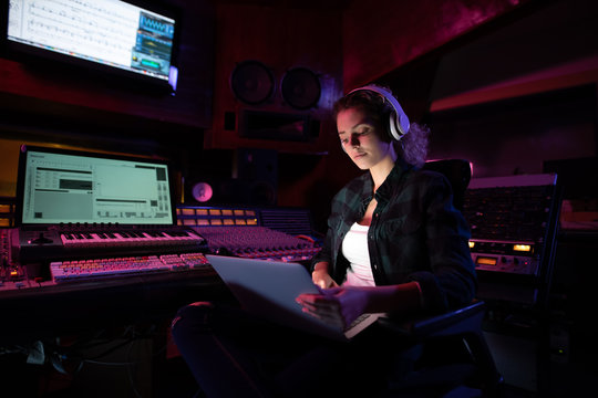Female music producer working in a sound studio