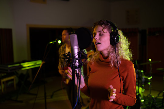 Female singer recording in a sound studio