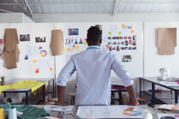 Young male student working on a project at a fashion college