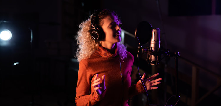 Female singer recording in a sound studio