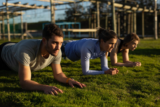 Young adults training at an outdoor gym bootcamp