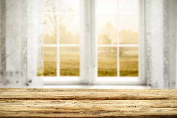 Blurred background of window and wooden table of free space for your decoration 