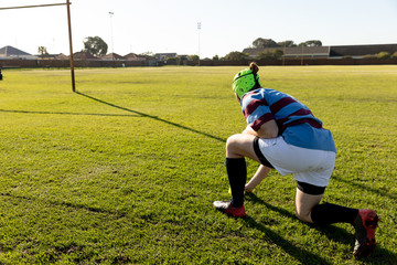 Young adult female rugby player on a rugby pitch