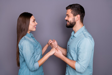 Close-up profile side view portrait of two her she his he nice attractive charming lovely cute cheerful cheery sweet tender person holding hands isolated over gray violet purple pastel background