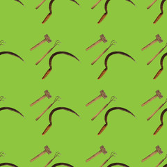 Seamless pattern with agricultural vintage tools on green background