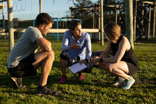 Young adults training at an outdoor gym bootcamp
