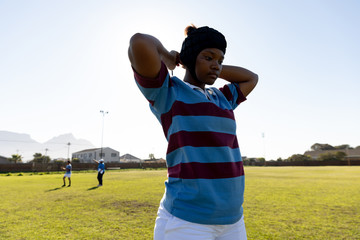 Young adult female rugby player on a rugby pitch
