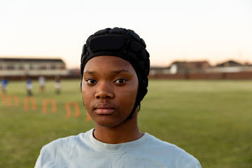 Portrait of young adult female rugby player on a rugby pitch