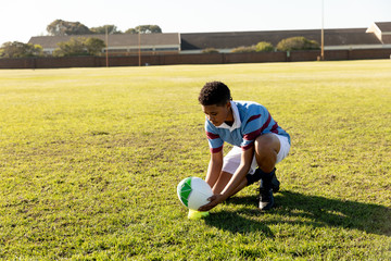 Young adult female rugby player on a rugby pitch