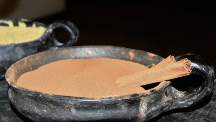 Cinnamon powder (ground) stick in a ceramic pot. Panoramic shot
