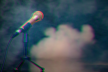 gold metal microphone on stage on a black background with fog. Digital signal glitch effect (rgb shift, slices). Screen error