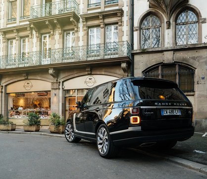 STRASBOURG, FRANCE - 13 MAR, 2018: New Range Rover Land Rover Vogue, the luxury British SUV parked in central French street near butcher shop Porcus Place du Temple Neuf