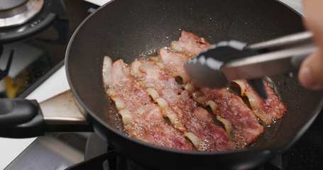 Cooking crispy bacon in the kitchen