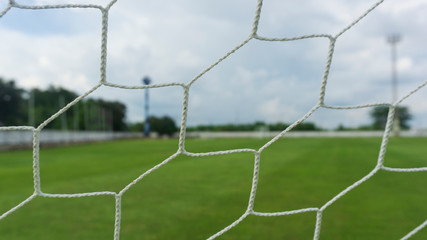 net goal soccer footballs green field background