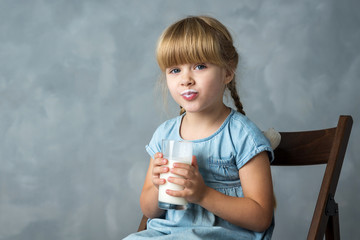little girl with a glass of milk, moustache of milk