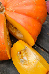 Orange pumpkins on a wooden table in the autumn landscape