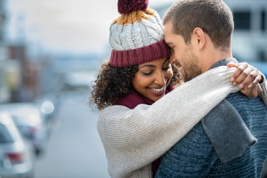 Happy couple in love embracing in winter