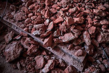Broken brick and rubbish next to an old ruined building. Dump. Urban economy.