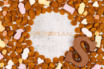 Dutch holiday Sinterklaas. Background with traditional food - pepernoten, chocolate letter, sweets strooigoed and carrots for horse. Concept for children party in Saint Nicolas day five december.