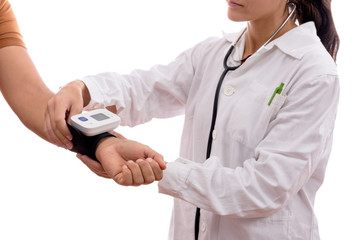 Caucasian young nurse girl with glasses taking blood pressure to a patient with a tensiometer in background isolated
