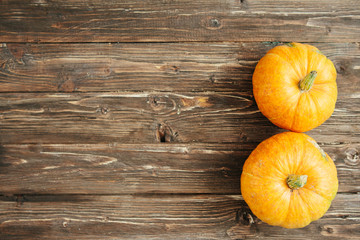 Pumpkins on brown wooden table, country autumn background. Organic food and healthy food concept Thanksgiving and Halloween concept. View from above. Top view. Copy space for text and design