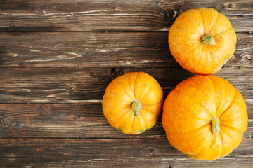 Pumpkin on a grunge wooden backdrop. Thanksgiving and Halloween concept. View from above. Top view. Copy space for text and design
