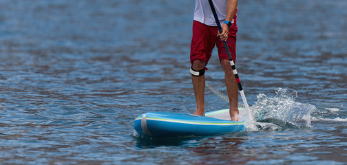 Stand up paddle board man paddle boarding on ocean