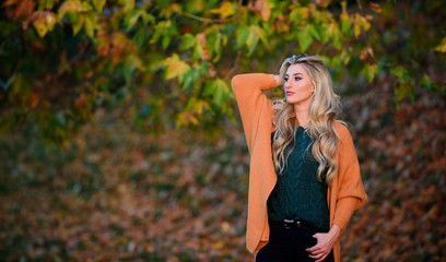 Fototapeta na wymiar Cozy casual outfits for late fall. Cozy outfit ideas for weekend. Woman walk sunset light. Comfortable outfit. Girl adorable blonde posing in warm and cozy outfit autumn nature background defocused