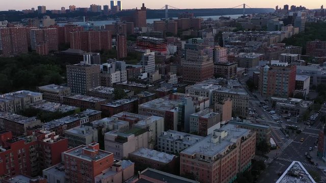 Aerial Flight Over The Manhattanville Part Of Harlem, NYC, Smooth Turning Towards Morningside Park, At Daybreak. 
The George Washington Bridge Is In The Distance.  In 4K.