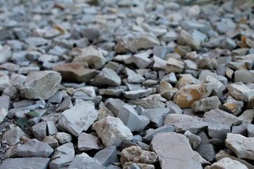 Abstract background with gray rocks. Sharp stones on the ground. Textured rocky backdrop with copy space for text
