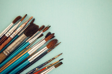 Obraz premium Set of paint brushes on the light blue background