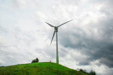 Fototapeta premium Landscape with a Windmill on the Hill and Cloudy Weather