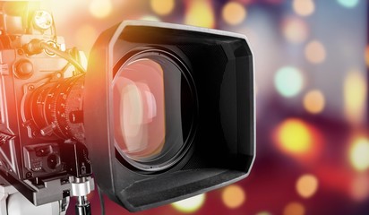 Close-up of a television camera lens on blurred background