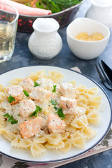 Farfalle with salmon in a creamy sauce, selective focus