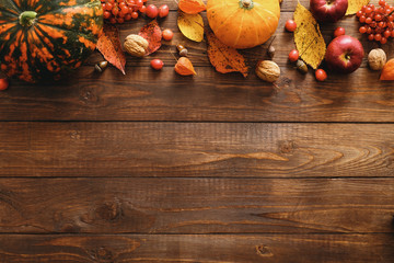 Happy Thanksgiving concept. Autumn composition with ripe orange pumpkins, fallen leaves, dry...