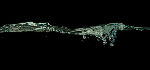 Water wave splash isolated black background.