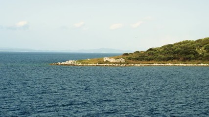Rocky shore. View of rocky mountain from the Mediterranean sea surface. Greece. 4K