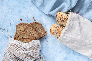 two seeded chiabattas and slices of bread in a zero waste cotton bag on a beautiful, clean, rustic,...