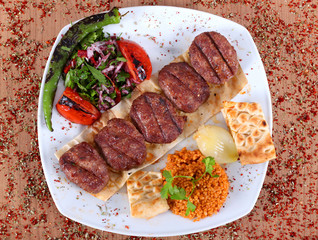 Turkish hamburger dumplings on a white plate from a high angle